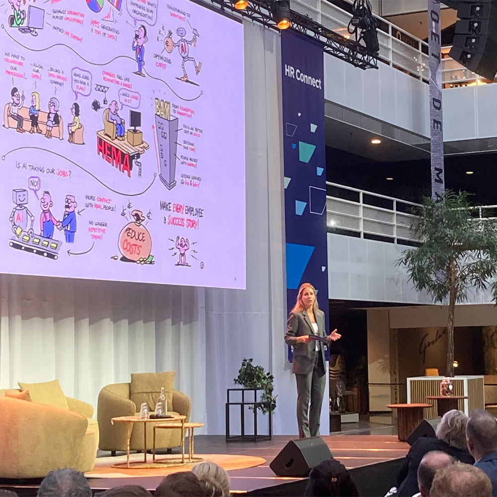 Vrouw presenteert op podium digitaal live tekenen op groot scherm